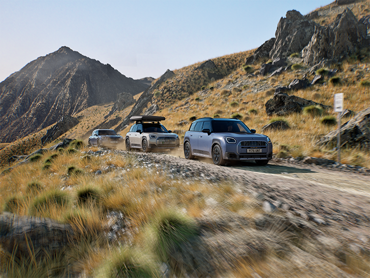 Imagem de vários modelos MINI Countryman Untamed Edition fora de estrada em montanha.